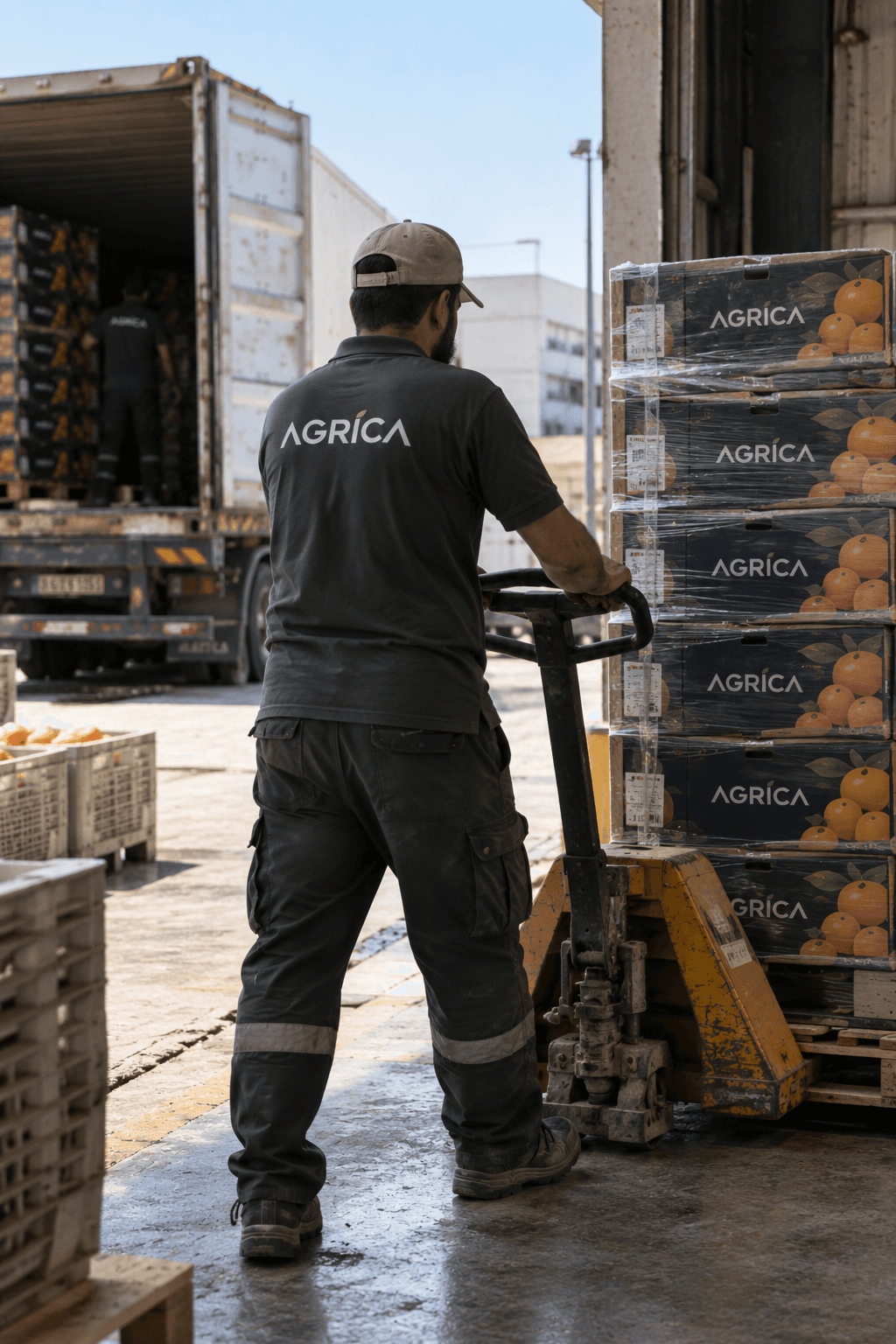 Logistics specialist pulling pallet jack loaded with AGRICA cartons